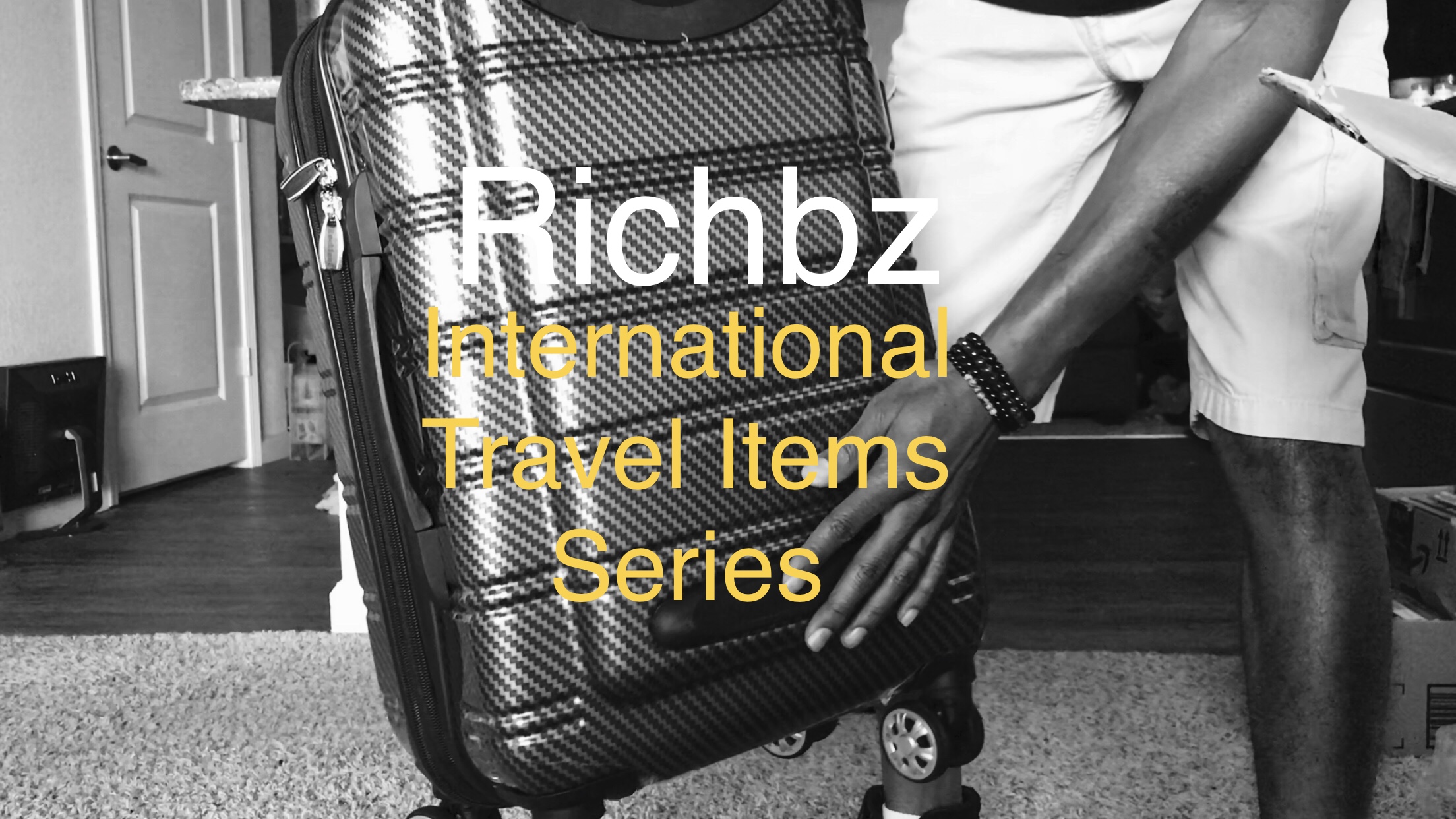 Richbz holding a Suitcase